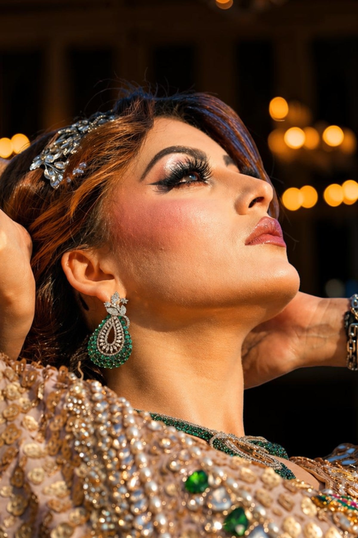 Urvashi Rautela wearing ornate jewelry with a blurred background