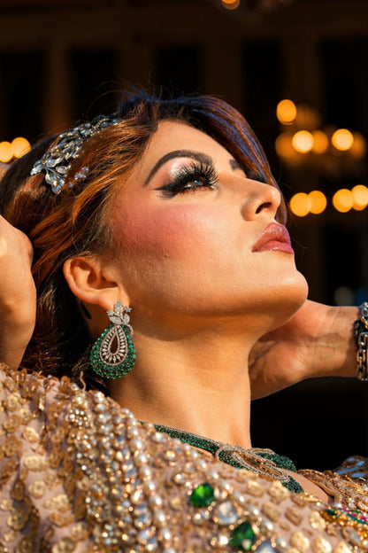 Urvashi Rautela wearing ornate jewelry with a blurred background